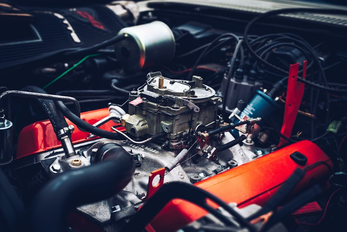 close-up of car engine bay with carb exposed, the diagnosis the customer already googled