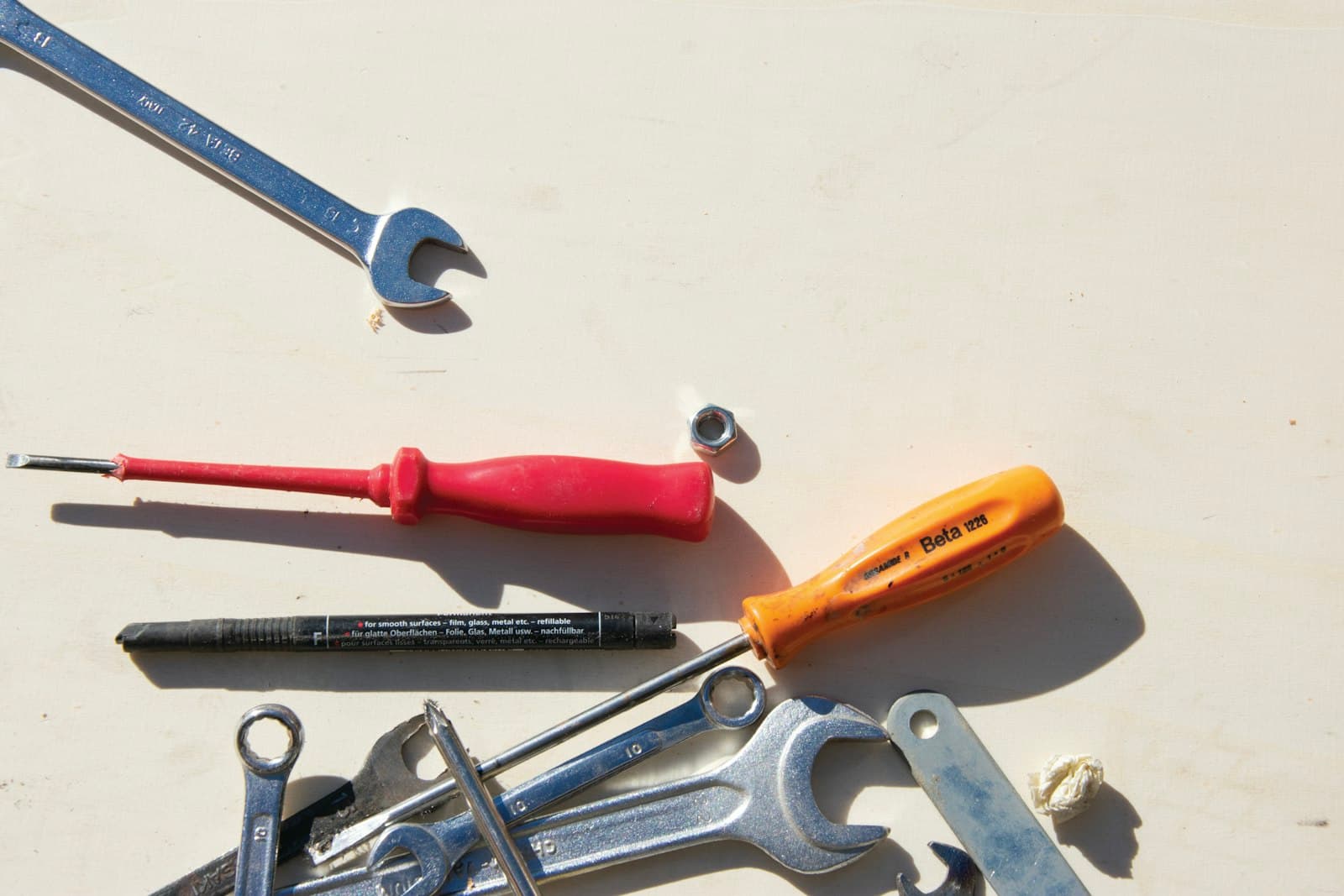 Wrenches and screwdrivers scattered on a workbench, the tech is out on a call