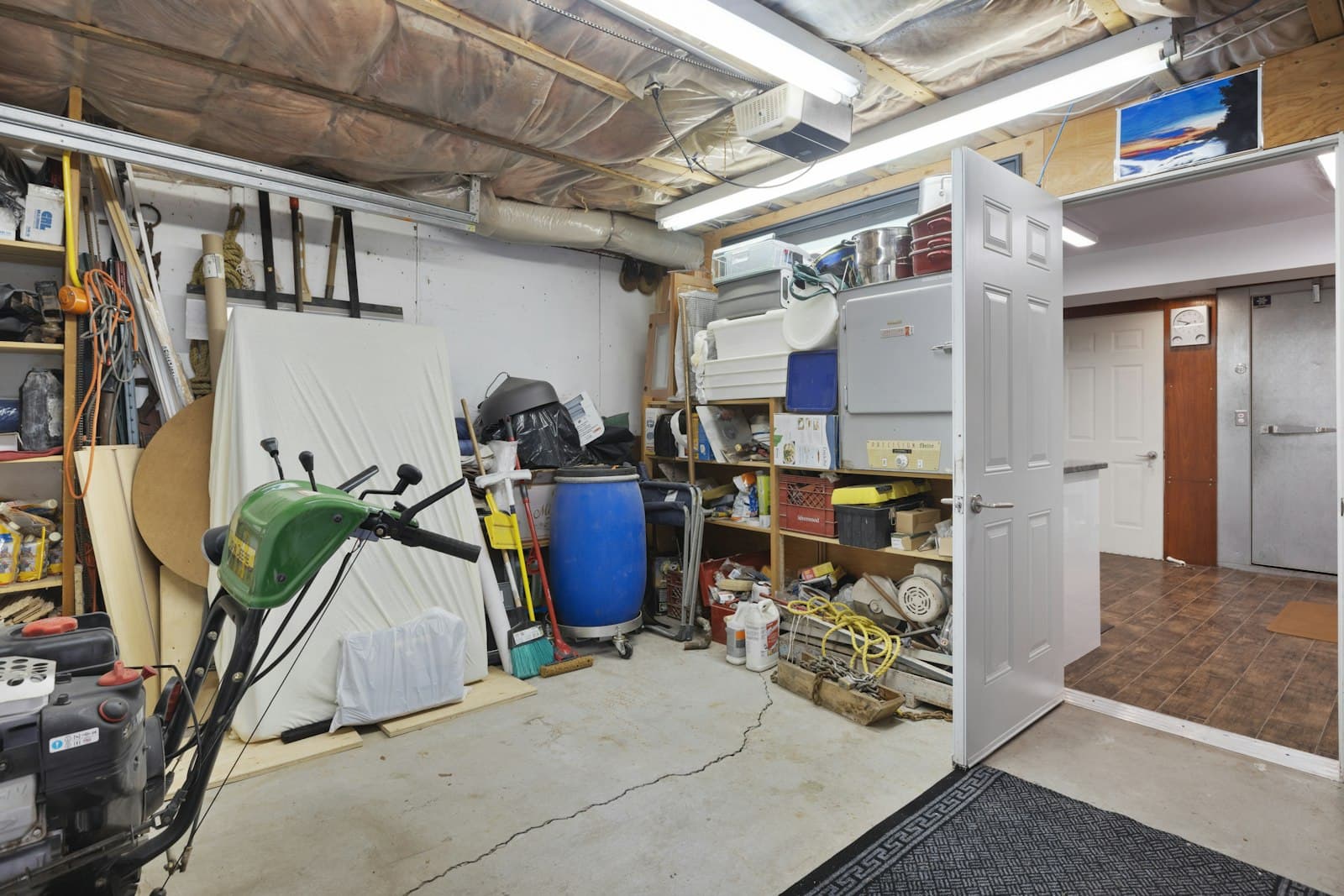 A garage packed wall to wall with clutter and old tools, a typical Miami cleanout job