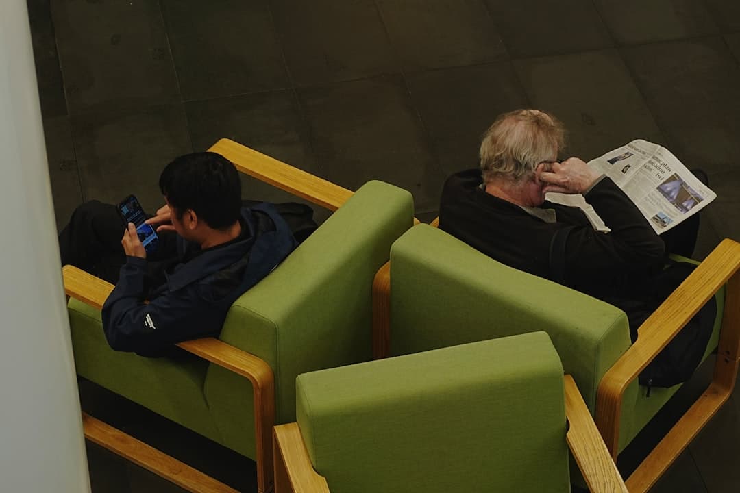 person in neck brace on phone in waiting room, already on the third firm's intake form