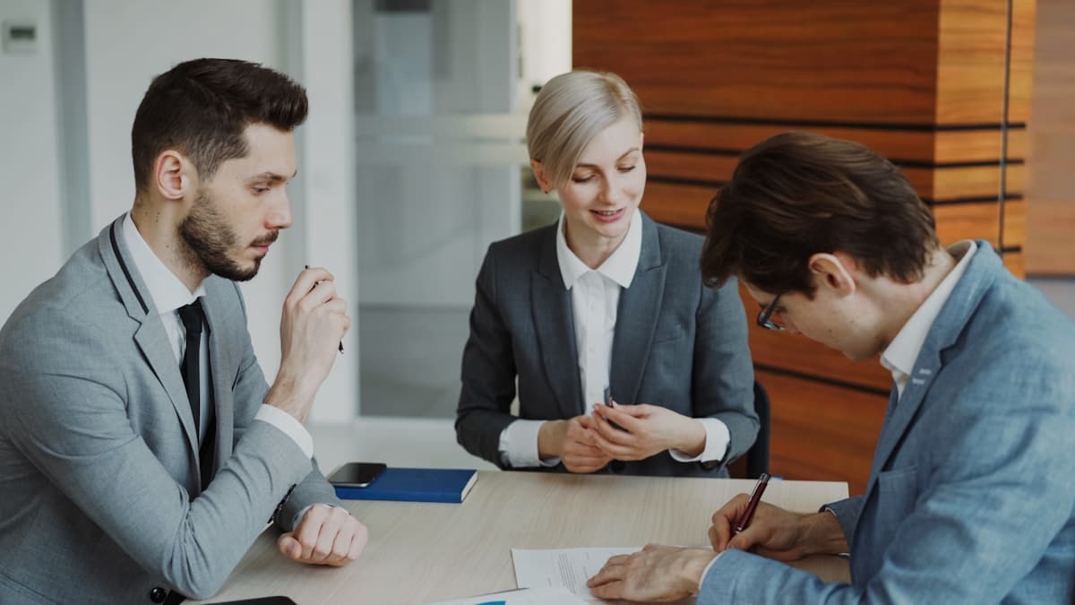 people signing a contract at a desk, retainer the night call earned
