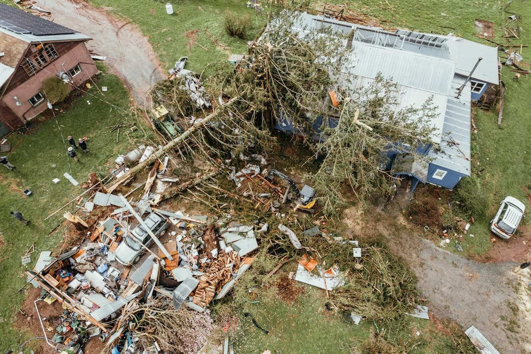 Aerial view of storm-destroyed house with fallen tree and scattered debris, Tampa hurricane-recovery leads landing fast