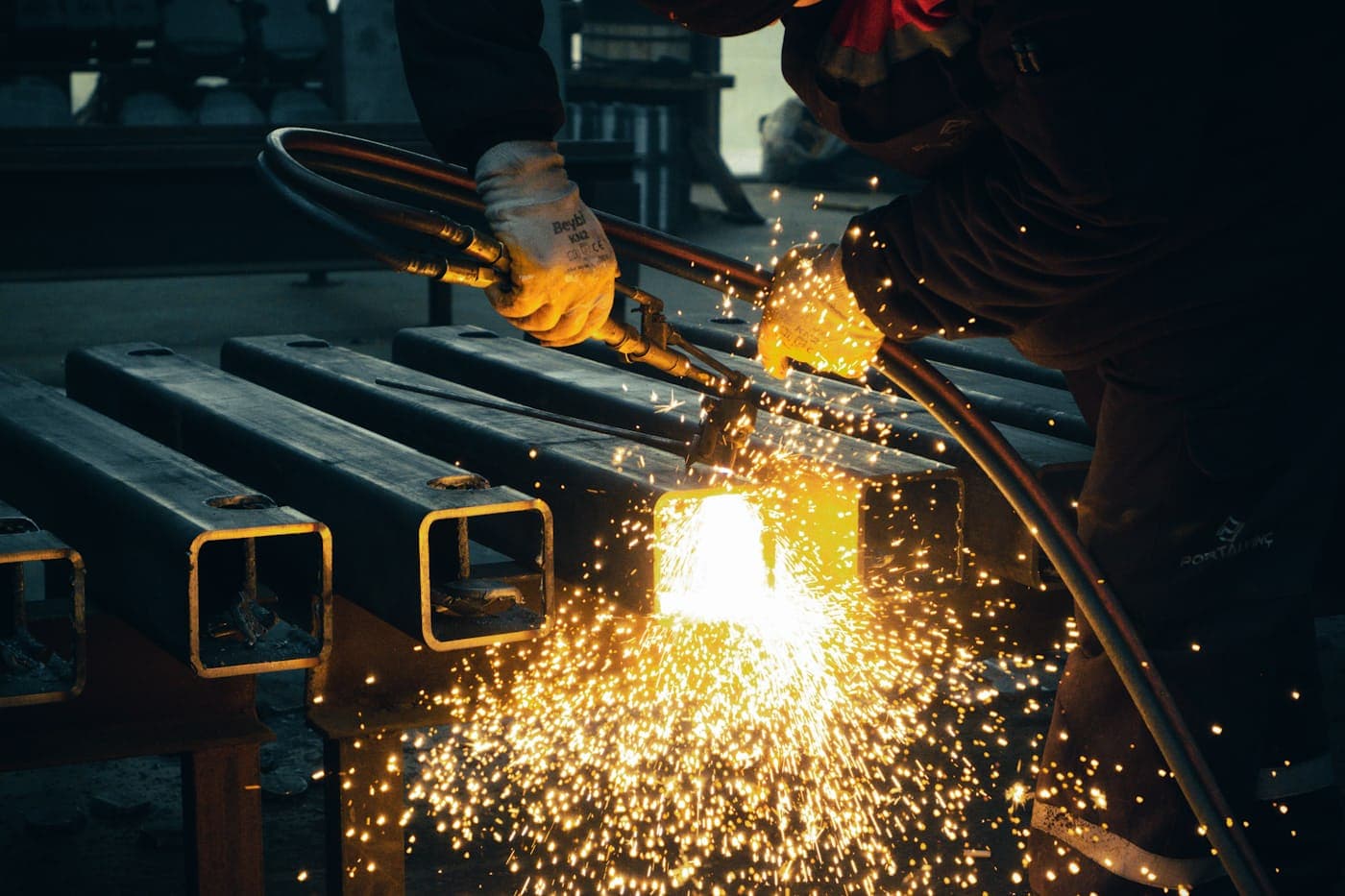 A fabricator torch-cutting steel box section for an equipment frame