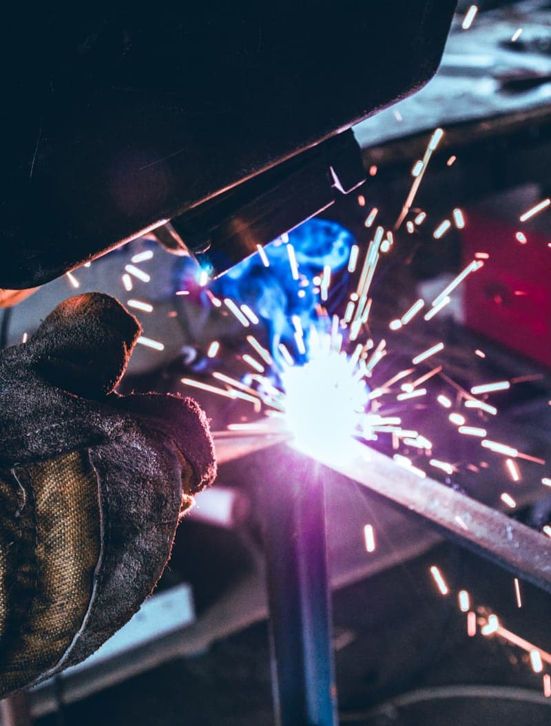 Close-up of a welder running a bead on a steel frame