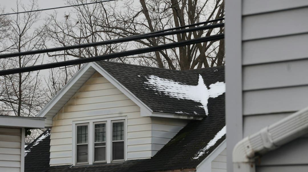 Shingles torn off a suburban roof after hail, storm damage calls already stacking up