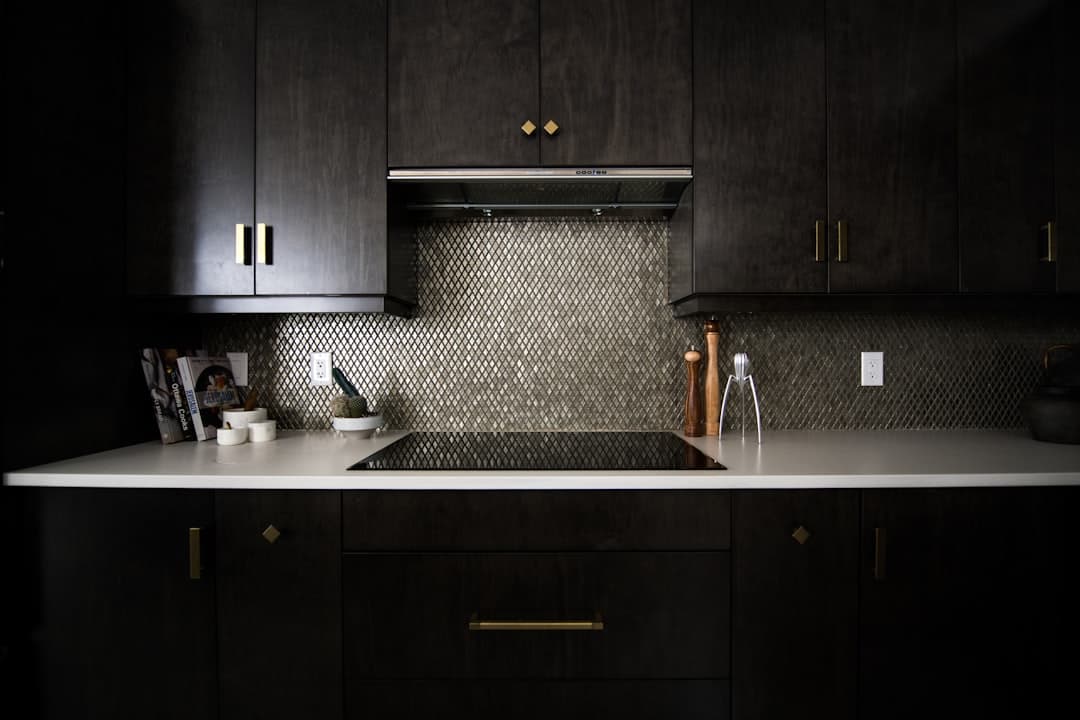 Homeowner on the phone in a dark kitchen, roofing leads rarely wait until morning