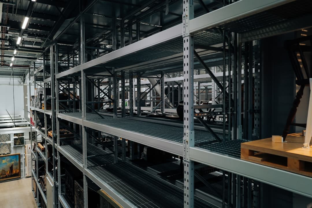 Gearboxes and spare components on metal shelving in a warehouse aisle