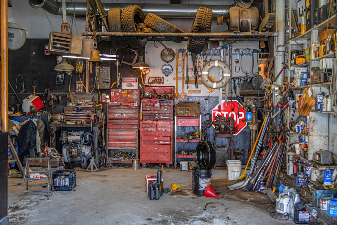 pegboard of black metal hand tools in a repair garage, the bays ready for the customer who never got texted back