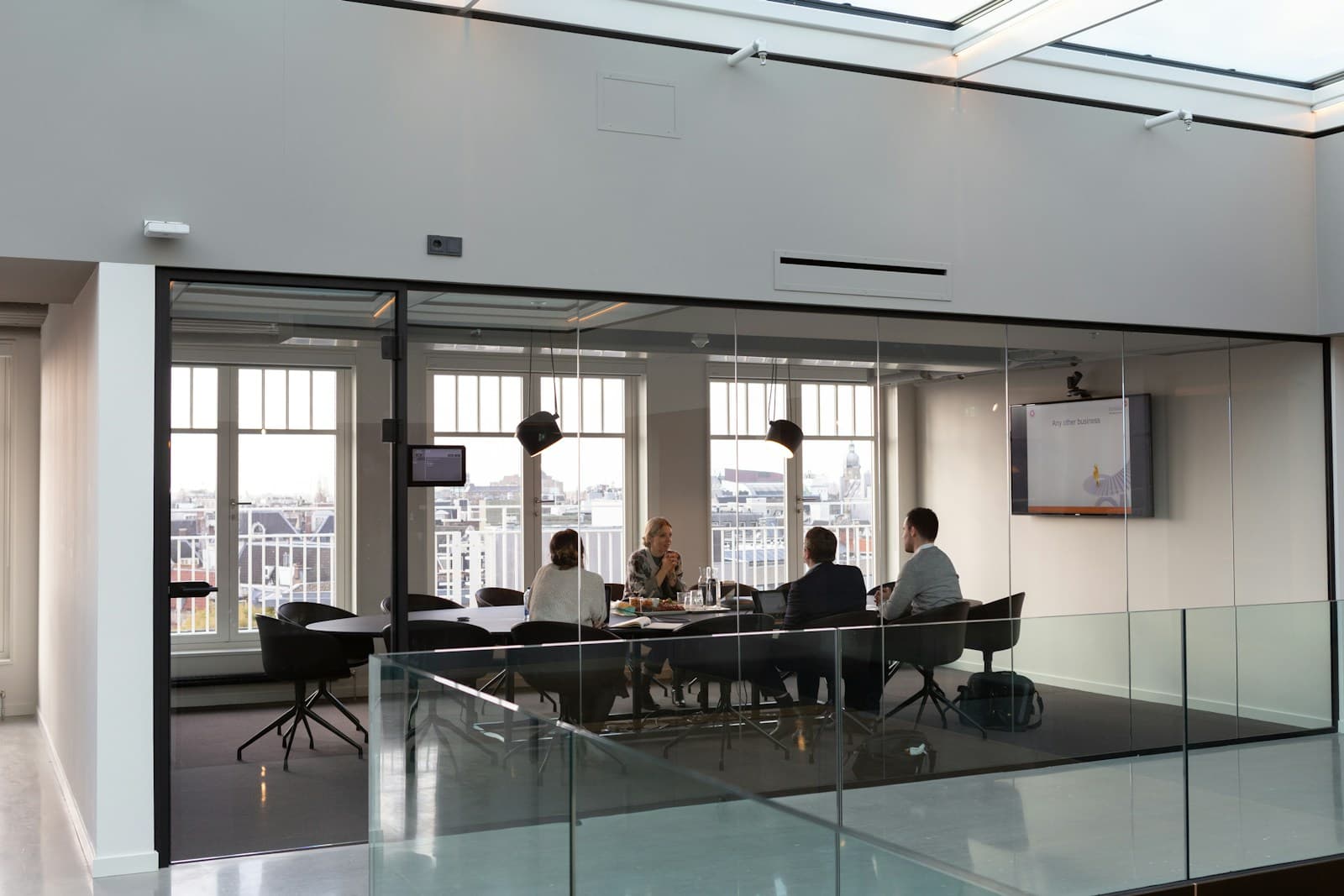 A conference room mid-pitch, everyone looking at the same slide