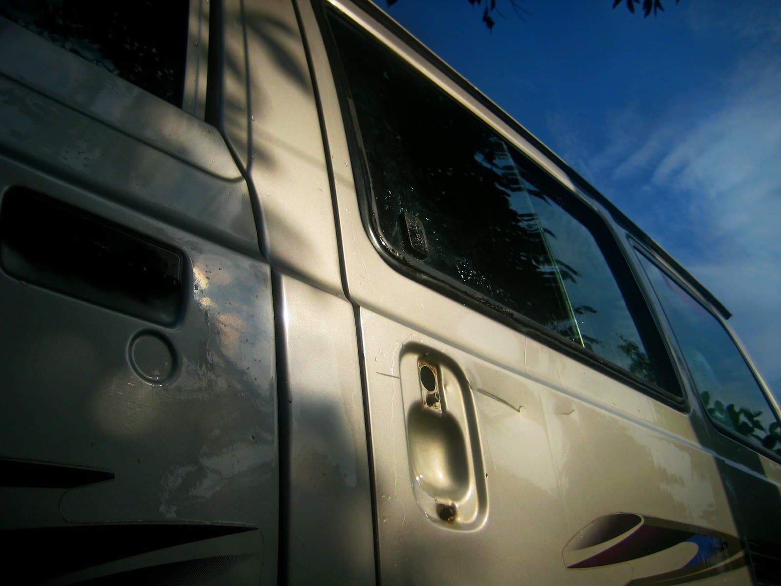 A mobile detailing van parked in a Miami driveway, waiting on the next booked wash