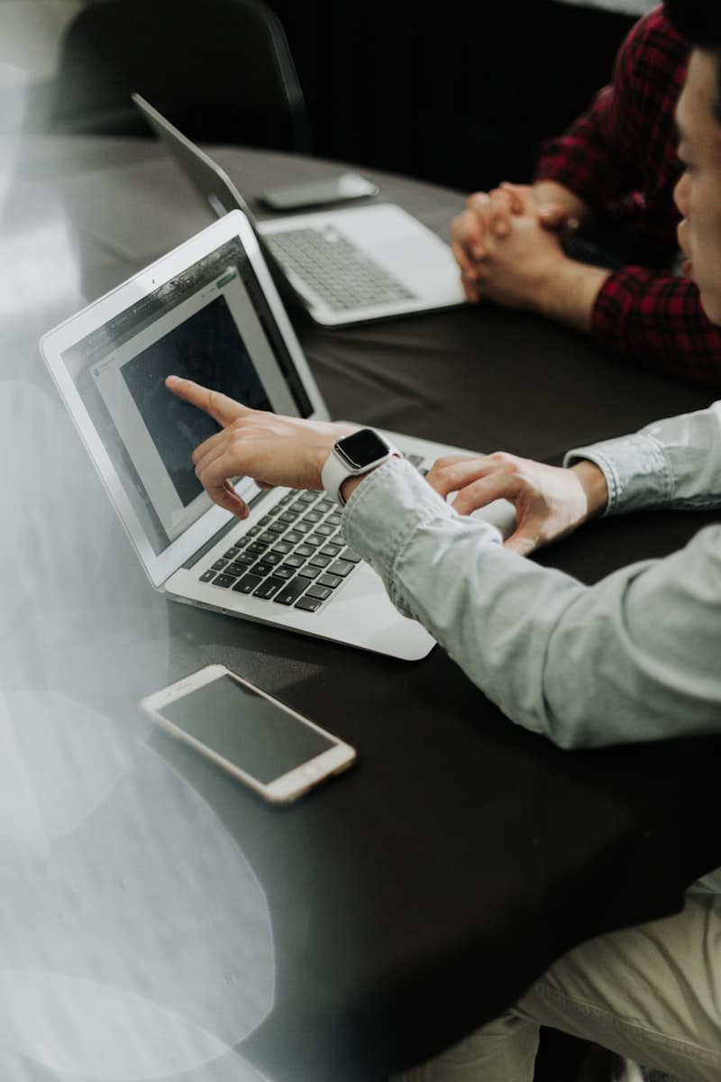 An advisor and client reviewing numbers on a laptop