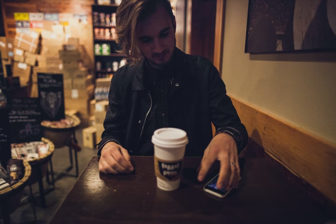 Small business owner staring at their phone, the kind of moment where AI for small business gets misused on captions instead of on the workflows that actually drive revenue