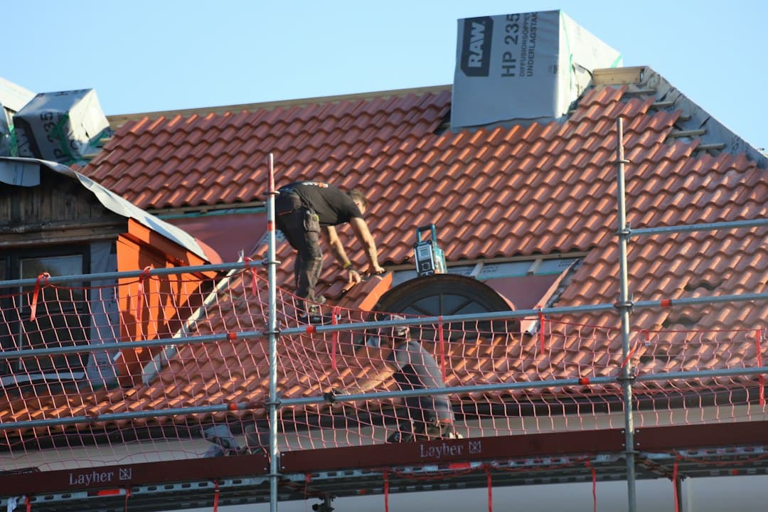 Roofing contractor working on a residential roof, a job booked through ads for contractors