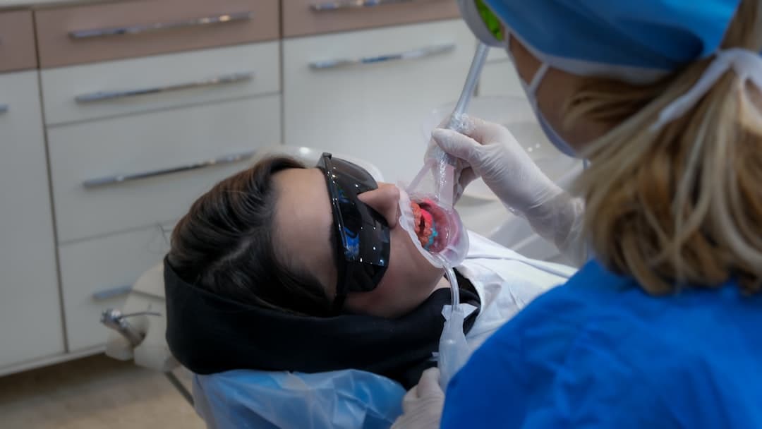 Salt Lake City dental practice patient receiving care in a modern operatory chair while automated reminder systems run in the background