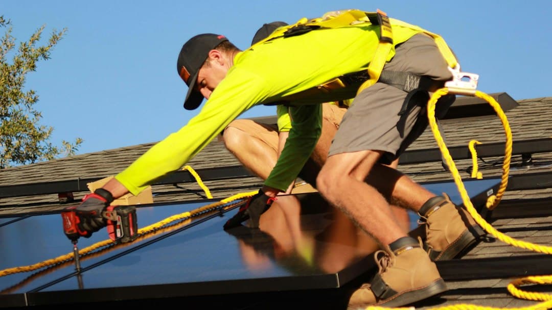 Residential technician beside an outdoor condenser, illustrating AI automation for HVAC scheduling in Tarrant County, Texas