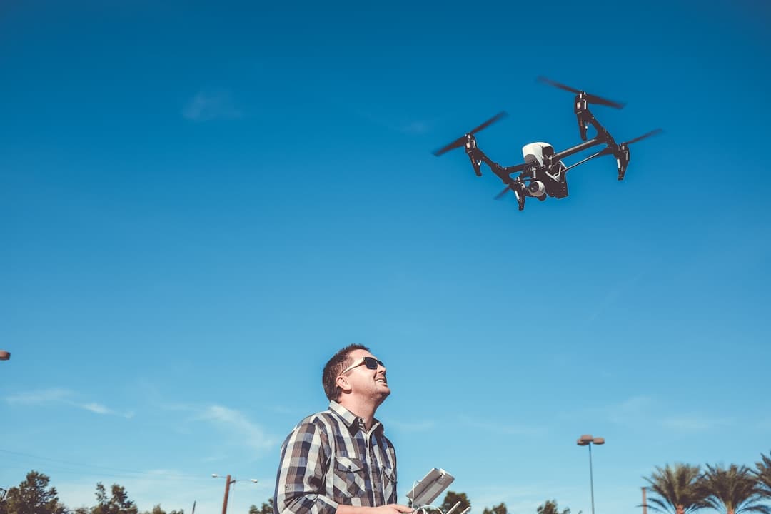 Tucson roofing tech launching an inspection drone from a driveway, ladder still strapped to the truck