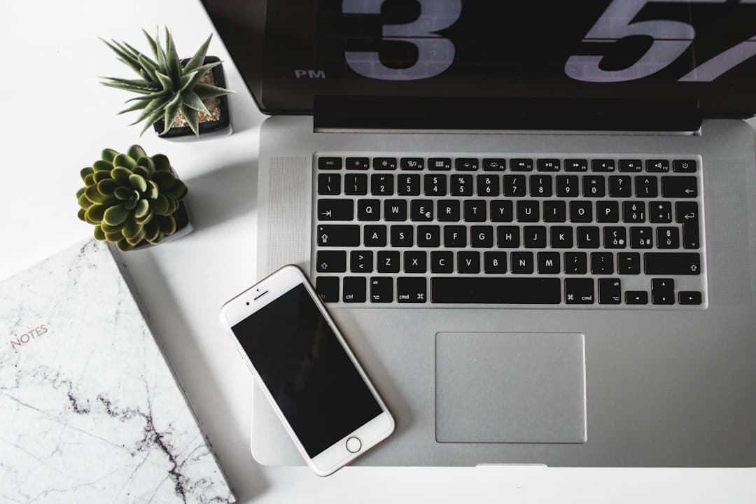 Laptop and phone on a desk with Daylite CRM automation open, every follow-up finally written down