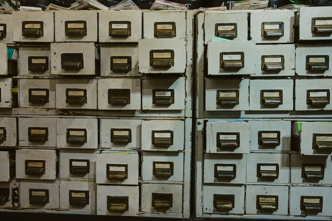 Filing cabinet drawer of client contact folders, a reminder that inactive contacts still count toward your monthly bill