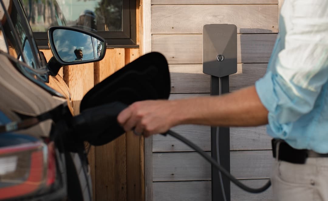 home EV charger mounted in a garage, the cable a homeowner is impatient to use