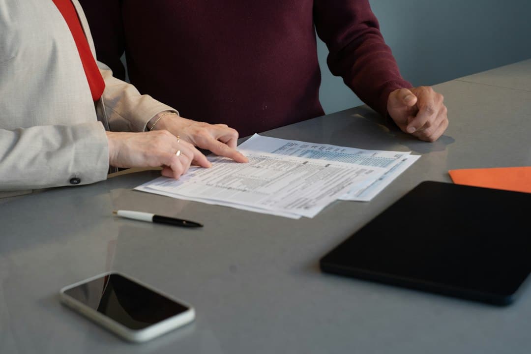 Event booking contract on a desk beside a laptop during quote follow up, deposit still pending