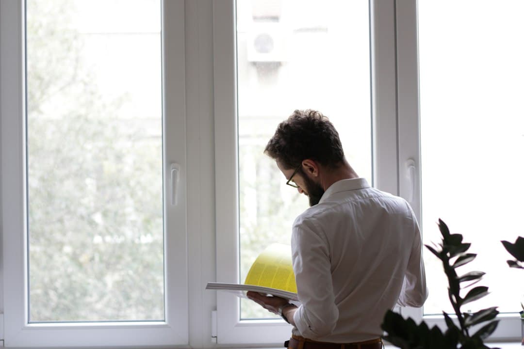 Contractor in a truck reviewing a home service marketing report on a tablet to see which ads booked