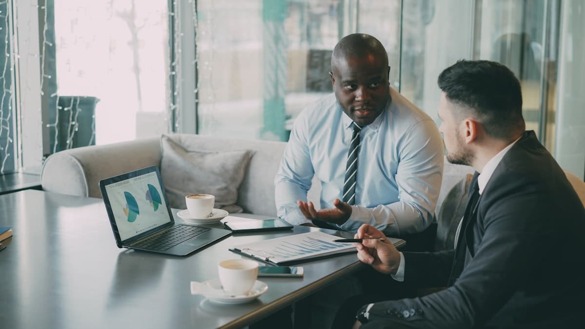 Two Atlanta life insurance professionals reviewing pipeline charts produced by their life insurance agent lead generation Atlanta system instead of dialing cold lists