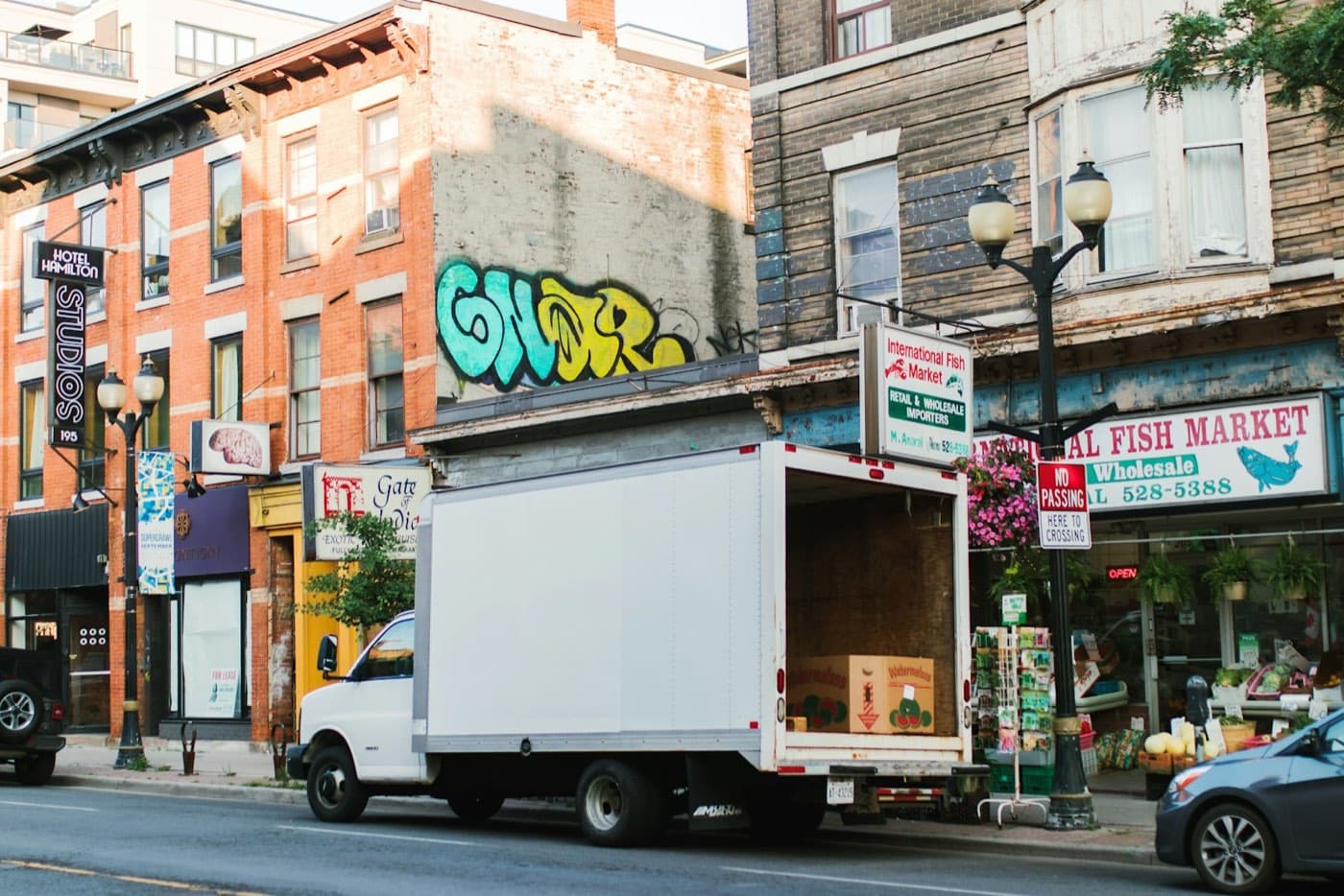 Box truck with its back open on a city street, the same-day haul someone booked an hour ago