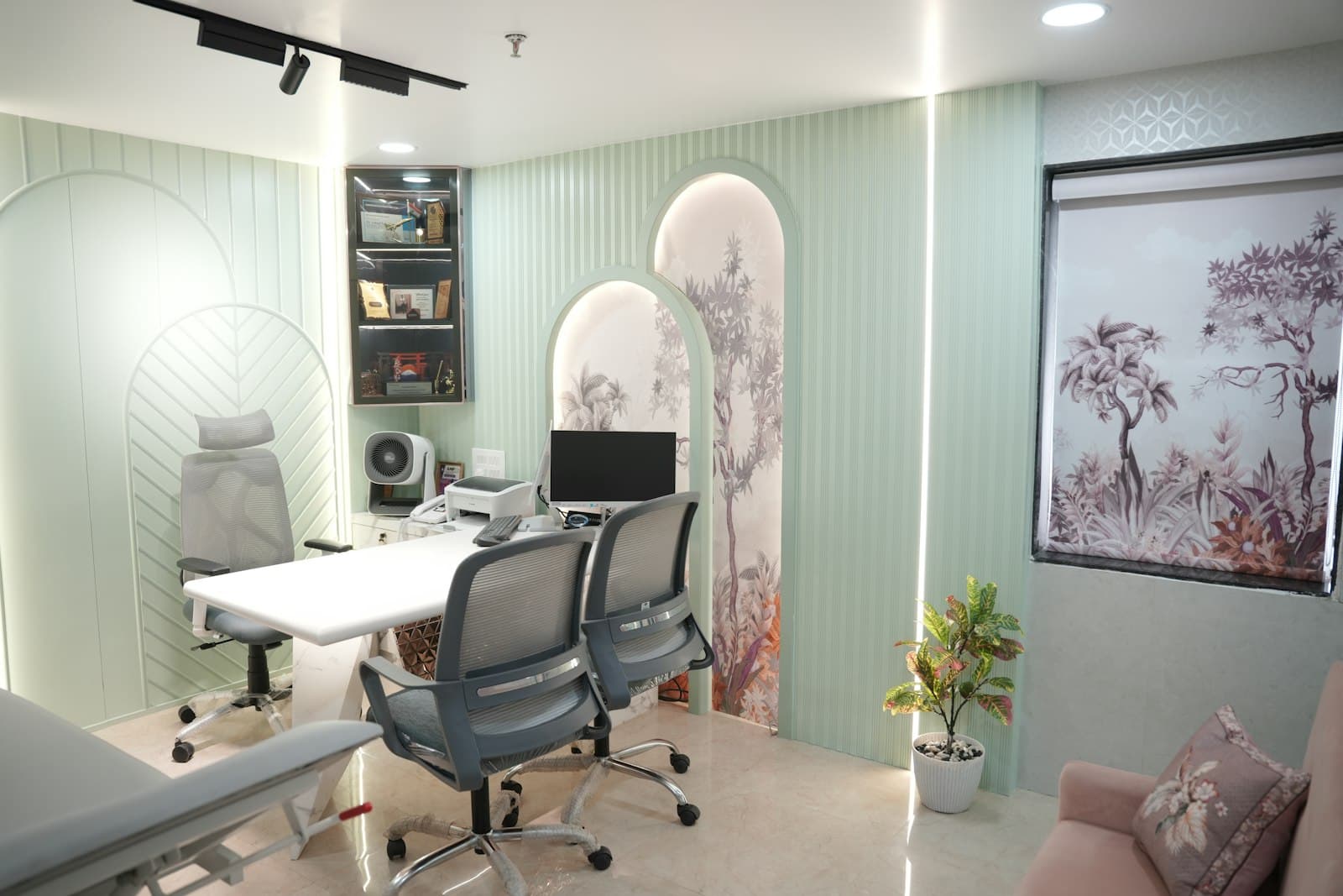 Medical spa consultation room with botanical murals and a treatment table, where the regulars used to book