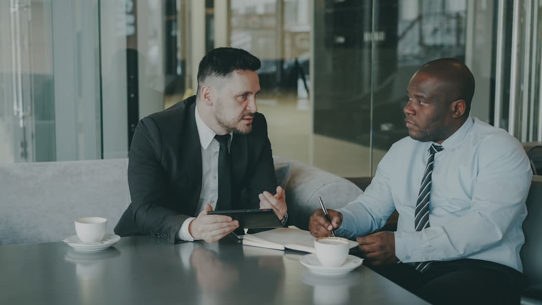 Personal injury attorney signing case engagement letter at law firm conference room
