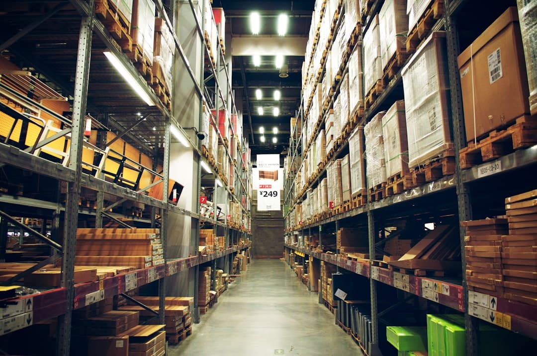 Warehouse parts shelves with bin labels and inventory tags, the stock a parts quote gets checked against