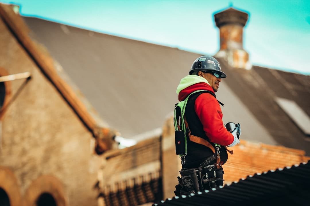 A Tampa roofer on the job site nailing down shingles while a storm-season lead capture system books his next three inspections, showing how roofing leads Tampa shops capture without leaving the roof