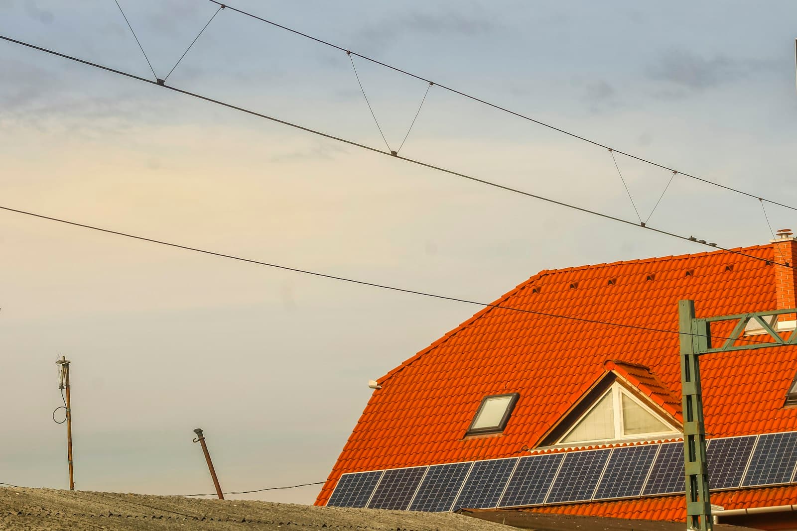 Solar panels along the edge of a tile roof at dusk, the install the neighbors will Google before they call